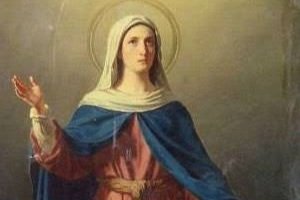 Imagem de uma santa de véu com as mãos erguidas em oração